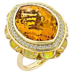 Citrine is natural wonder that come in all shapes and colors. A citrine stone will bring a ray of sunshine into your life! The opals that surround the ring contribute to its beauty and elegance. These lovely stones are wonderful gifts for anyone and may be worn as jewelry or hung as ornaments on the tree. Citrine Fancy Ring in 18Karat Yellow Gold with Opal and White Diamond. Citrine: 17.04 carat, 20X15mm size, marquise C/B shape. Opal: 3.45 carat, 6X4mm size, round. oval shape. White Diamond: 0. A Ray Of Sunshine, Fancy Rings, Gifts For Anyone, Ray Of Sunshine, Citrine Stone, Aqua Marine, Naha, Shapes And Colors, Earrings Rings