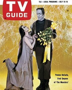 a magazine cover with a man and woman dressed in costumes on the cover, holding flowers