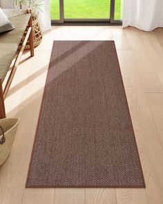 a brown area rug in front of a window