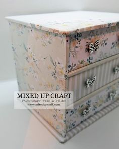 an old dresser with flowers and butterflies painted on the drawers is featured in this image