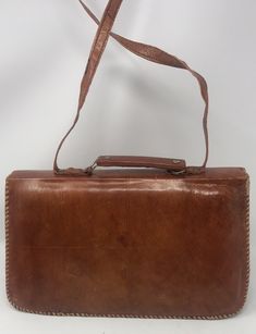 "11 1/2 inches in length /7 inches in height /3 1/2 inches the bottom width, 1 1/4\" width at the top/good vintage condition /clean.strap drop is 16 inches/Top handle or strap/snap closure/one interior small zip compartment(P11)" Handmade Tote Satchel For Formal Occasions, Vintage Satchel Flap Bag For Formal Occasions, Vintage Crossbody Satchel For Daily Use, Handmade Formal Crossbody Shoulder Bag, Formal Handmade Crossbody Shoulder Bag, Vintage Handheld Shoulder Bag With Adjustable Strap, Traditional Brown Shoulder Bag For Formal Occasions, Formal Brown Handmade Bags, Vintage Brown Satchel Shoulder Bag With Leather Lining