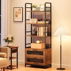 a living room filled with furniture and a book shelf next to a lamp on top of a hard wood floor