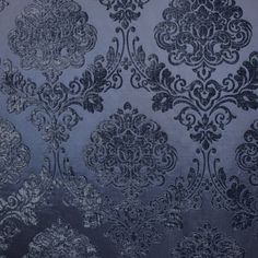 a blue and black wallpaper with an ornate design on the back side of it