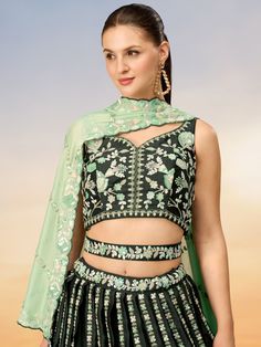 Indulge in the richness and elegance of our stunning green embroidered satin mehendi wear lehenga choli. This exquisite ensemble features a green color satin lehenga adorned with intricate sequin and coding thread embroidered work, complemented by a satin choli with similar embroidery details. The outfit is completed with a green color georgette dupatta embellished with sequin work ethnic motifs and embroidery cutwork border.
The semi-stitched lehenga is designed to fit up to 42 inches with a 3. Lehenga Green, Bride Looks, Satin Lehenga, Lehenga Crop Top, Three Quarter Sleeve Blouses, Lehenga Choli Wedding, Traditional Silk Saree, Stitched Lehenga, Bollywood Lehenga