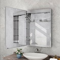 a bathroom sink sitting under a large mirror