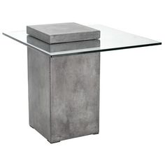 a table with a square glass top and concrete base on the bottom, sitting against a white background