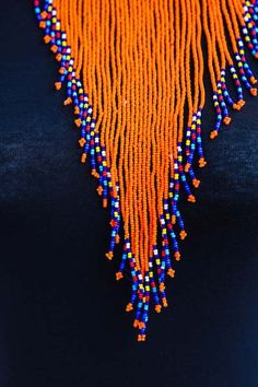 MTWAPA Zulu Choker necklace made using 100% fine beads.

Color: Orange

Closure: hook

Length: 18 inches long

Material: Beads, wire and brass

It is made on order hence it's ready to ship within 1-3 days.

Shipping cost is calculated during checkout.

DHL Express shipping that takes  3-5 days to be delivered Elegant Colorful Bead Choker Necklace, Orange Beads As A Gift, Gift Beaded Necklaces 16 Inch, Orange Beaded Necklaces As Gift, Gift Beaded Necklace 16 Inch Length, Party Choker Necklace With Colorful Beads, Unique Long Beaded Necklace, Colorful Beads Choker Bib Necklaces, Long Necklace Beads For Party