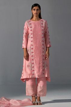 Pink kurta featuring zardozi embroidery embellished with floral applique and sequin work. Comes with matching pant and scalloped edge dupatta.
Components: 3
Pattern: Embroidered
Type Of Work: Zardozi
Neckline: Round
Sleeve Type: Full
Fabric: Bemberg Silk, Organza 
Color: Pink
Other Details: 
Length:
Kurta: 38-39 Inches 
Pant: 40 Inches
Occasion: Sangeet,Mehendi and Haldi - Aza Fashions Spring Chanderi Salwar Kameez With Mirror Work, Designer Embroidered Dola Silk Palazzo Set, Festive Straight Kurta Pant Set With Mirror Work, Festive Pant Set With Mirror Work And Straight Kurta, Unstitched Sets For Reception With Straight Kurta, Spring Chanderi Anarkali Set With Mirror Work, Eid Cotton Silk Palazzo Set With Dabka Work, Unstitched Palazzo Set With Resham Embroidery And Straight Kurta, Cotton Silk Palazzo Set With Dabka Work For Eid