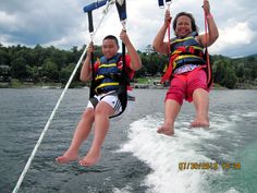 two people on water skis being pulled by a boat