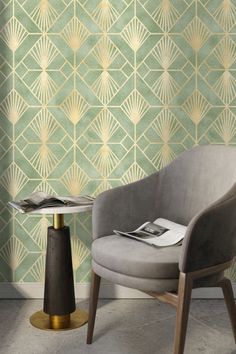 a chair and table in front of a wallpapered room with gold geometric designs