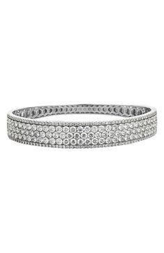 The intense shine of 18-karat gold is emphasized with 210 icy diamonds in this handcrafted bangle. 7" inner circumference Total diamond weight: 7.75ct. Color: G Clarity: VS 18k gold/diamond Imported >Diamond Guide