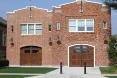 a brick building with two brown doors and windows