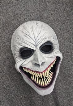 an overhead view of a creepy mask with teeth and fangs on it's face