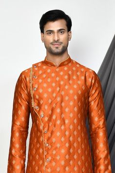 Orange full sleeve kurta with floral jacquard woven motifs and mandarin collared neckline. Paired with cream dhoti pant. - Aza Fashions Designer Festive Kurta With Traditional Patterns, Ceremonial Kurta With Traditional Patterns And Long Sleeves, Long Sleeve Kurta With Traditional Patterns For Diwali, Transitional Kurta With Traditional Patterns And Drape, Traditional Patterned Long Sleeve Churidar For Festivals, Festive Straight Kurta Bandhgala With Traditional Patterns, Long Sleeve Churidar With Traditional Patterns For Festivals, Festive Designer Sherwani With Traditional Patterns, Bandhgala With Traditional Patterns For Diwali