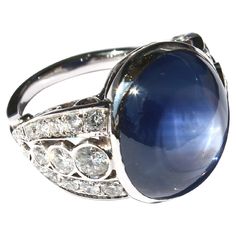 Ring made of gold 18k set with a center Ceylon cabochon ring of 25.81 Carats, 2 diamonds of 0.38 Carats, and 1.03 carats diamonds. Total weight of diamonds: 1.41 Carats (H color - Vs clarity) Luxury Classic Sapphire Ring Oval Cabochon, Fine Jewelry Sapphire Cabochon Ring With Diamonds, Elegant Sapphire Ring With Cabochon Diamond, Elegant Sapphire And Diamond Ring With Cabochon Cut, Luxury Diamond Cabochons For Wedding, Sapphire Cabochon Diamond Ring, Luxury Cabochon Diamond Ring For Formal Occasions, Luxury Sapphire Cabochon Ring For Anniversary, Sapphire Oval Cabochon Ring With Diamonds