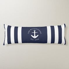 a navy and white striped pillow with an anchor on it