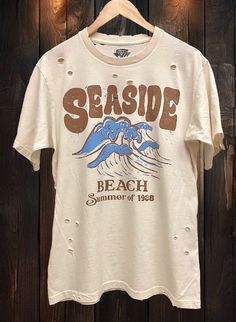 Country Deep Seaside Beach Summer of 1988 Vintage unisex distressed T shirt in vintage natural color Vintage country western cowboy T shirt 40 Singles Jersey 100% Cotton Premium quality ringspun and compacted cotton Fine Cotton Jersey that is pigment dyed for a more vintage look Features tears and destroyed features at neck and on body Each piece is unique as this process is done by hand! 3.8 oz Made In USA Every garment dye item can be a slightly different shade in color and distressed since th Vintage Washed T-shirt For Spring, Relaxed Fit Bleached T-shirt For Summer, Summer Bleached Relaxed Fit T-shirt, Faded Distressed T-shirt For Summer, Faded Retro T-shirt For Summer, Vintage Summer Beach T-shirt, Faded Washed T-shirt For Summer, Summer Faded Washed T-shirt, Faded Soft-washed Summer T-shirt