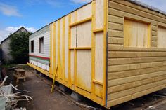 a small house being built on the side of a road