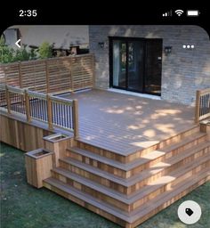 a large wooden deck with steps and railings