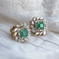 Our take on classic solitaire studs, the Eden holds a faceted gemstone at its heart, with pave-set diamonds and prong-set marquise diamonds giving it company. Baguette Cut Diamond Earrings With Accents, Emerald Cut Diamond White Earrings With Diamond Accents, Emerald Cut Diamond White Earrings With Accents, Wedding Diamond Earrings With Baguette Cut, Classic Emerald Diamond Earrings Gia Certified, Classic Gia Certified Emerald Diamond Earrings, Formal Emerald Earrings With Diamond Accents, Gia Certified Diamond White Diamond Earrings, Luxury Moissanite Diamond Earrings For Wedding