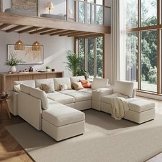 a living room filled with furniture and large windows