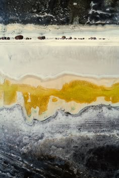 an abstract painting with yellow and white colors on the bottom half of it, as well as black background