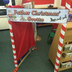 a sign that says father christmas's grottoo in front of some bookshelves