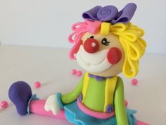 a toy clown sitting on top of a table