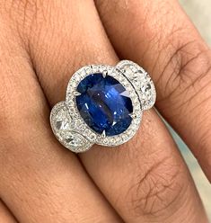 An enviable jewel, this ring sports some dazzling Diamonds & a sparkling Sapphire. Gemstones Type: Sapphire Gemstones Shape: Oval Gemstones Weight: 5.38 ct Gemstones Color: Blue Diamonds Shape: Round & Marquise Side Diamonds Weight: 2.13 ct Side Diamond Color: F - G Side Diamond Clarity: VS (Very Slightly Included) Metal: 18K White Gold Metal Wt: 7.7 gms Setting: Prong & Pave Set Finger Size: 7 To have the ring sized, please note the desired size in Special Instructions during checkout. Luxury Gia Certified Platinum Gemstones, Luxury Gia Certified Diamond Gemstones, Luxury Cluster Sapphire Ring Gia Certified, Luxury Gia Certified Cluster Sapphire Ring, Luxury White Gold Gia Certified Gemstones, Luxury Gia Certified White Gold Gemstones, Luxury Gia Certified Gemstones, Luxury Gia Certified Diamond White Sapphire Ring, Luxury Oval Platinum Gemstones