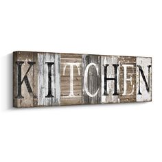 a wooden sign with the word kitchen painted in white and brown on top of it