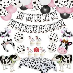 a cow themed birthday party with black and white balloons