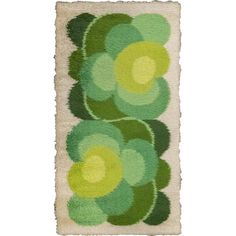 a rug with green and yellow flowers on it's sides, in the shape of circles