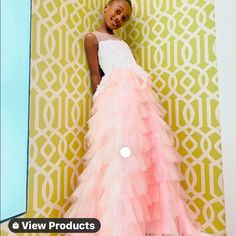 This Gown Is Beautiful And Feminine With Layers Of Frothy Tulle And Ruffles. The Ruffle Panels Create A Flattering Textured Playful Look. Pink Skirt With White Embellished Bodice. Perfect For The Holidays, Cotillions, And Junior Proms. Sizes 2-13. Special Order If You Do Not See Your Size. Allow 14 Days For Delivery After You Place The Order. Tulle First Communion Dress Ball Gown, Ruffled Ball Gown Pageant Dress, Organza Princess Dress With Ruffles For Prom, Ruffled Ball Gown Princess Dress For Prom, Ball Gown Princess Dress With Ruffles For Prom, Prom Princess Dress With Ruffles, Sleeveless Ruffled First Communion Dress For Pageant, Sleeveless Ruffled First Communion Dress For Pageants, Pageant Organza Gown With Ruffles