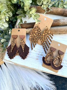 Earrings are made from a textured tan and deep brown cracked pattern genuine leather and pebbled solid brown genuine leather! Select the style from the drop down menu.  Retro fringe - Earrings are made from three layers of fringe and topped with a wooden half circle stud. Earrings measure approx 3" long.  Fringe Feather - A single layer of styled side fringe on one side. Earrings measure approx 3 1/2" long.  Teardrop - Earrings are made from two layers of leather and topped with a wooden half ci Bohemian Brown Pierced Earrings, Artisan Brown Earrings For Pierced Ears, Artisan Brown Pierced Earrings, Unique Brown Teardrop Earrings, Earthy Brown Dangle Earrings, Earthy Brown Drop Earrings, Artisan Brown Teardrop Earrings, Rustic Brown Adjustable Earrings, Rustic Brown Drop Earrings