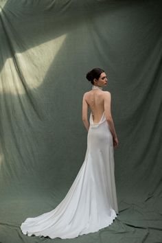 a woman in a white dress is standing back to back