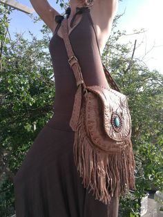 "Boho purse, Leather Fringe Bag, Fringe shoulder Bag, Brown Leather, Turquoise Stone, Hippie Bag, Boho Bag, Ibiza Bag, Handmade Bag Light Brown leather bag with fringe and Turquoise Stone Fully lined inside with one pocket and a inside pocket with zip. Strap can be adjustable to several lengths. Handmade and the best finishing quality. Dimensions: Main pocket with brass magnet: [10\"X9.5\"] or [26cmX24cm] Inside zipper pocket: [5\"x5\"] or [13x13cm] Fringe [8.5\"] or [22cm] Notes: 1) Since every Bohemian Pouch Shoulder Bag With Hand-stitched Details, Handmade Artisan Satchel For Festivals, Artisan Handmade Satchel For Festivals, Bohemian Hand-stitched Tote Shoulder Bag, Bohemian Hand-stitched Crossbody Bag, Handmade Hippie Shoulder Bag For Festival, Hippie Handmade Shoulder Bag For Festival, Festival Crossbody Satchel With Removable Pouch, Handmade Satchel Shoulder Bag For Festival