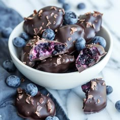 a bowl filled with chocolate covered blueberries