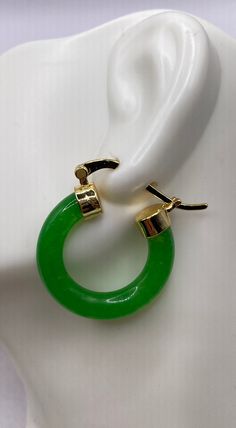 "These are lovely Green Jade Hoop Earrings  Approximately 1 inch See our full collection of Vintage Jade: https://www.etsy.com/shop/EastVillageBangles?section_id=38654118 Jade, a birthstone of August, is often the gemstone associated with the twelfth wedding anniversary.  Jade comes in Nephrite and Jadeite varieties, each a crystallized form of silica. Jade draws its name from the Latin ilia, meaning 'flanks, kidney area' giving rise to the informal \"loinstone\".  Jade is known as a symbol of good luck, longevity, and wisdom promoting self acceptance and love. Jade brings a restoring energy balancing Heart chakra.   Jade is a relatively hard stone rating 6.5 on the Mohs scale.  Jade can be cleaned with mild soap in warm water, and a soft toothbrush or cloth.  Avoid harsh cleansers, bleach Cheap Handmade Jade Earrings, Affordable Jade Bead Earrings, Elegant Small Hoop Green Earrings, Elegant Green Hoop Huggie Earrings, Elegant Green Small Hoop Huggie Earrings, Elegant Green Hoop Earrings, Green Hoop Huggie Earring, Green Hoop Jewelry With Matching Earrings, Single Green Hoop Earring