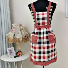 a mannequin wearing a red and white checkered apron