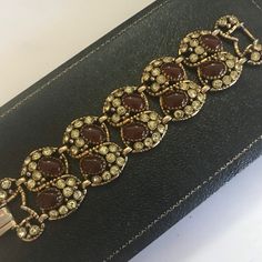 "ON SALE Vintage Selro Rhinestone Chunky Bracelet - Retro 1950's 1960's - Hard To Find Jewelry Old Hollywood Regency Glamour offered by MartiniMermaid on etsy Style: Retro 60's High End Designer Color: gold tone metal, light yellow rhinestones & brown glass cabochons Bracelet approximate Size: 7 1/2\" x 1 1/2\" Condition: Very good well taken care of & cherished condition Approximate Date: 1950's - 1960's Hallmarks/signature: Unsigned but attributed to Selro Stunning statement jewelry th Old Hollywood Regency, Mod Earrings, 1950s Bracelet, Chunky Bracelet, Chunky Bracelets, Wide Bracelet, Metal Light, Statement Bracelet, Rhinestone Bracelet