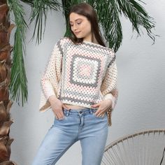 This cozy and unique sweater is a bohemian-inspired masterpiece, perfect for anyone who loves a vintage and handmade touch. The sweater is crafted using the traditional crochet technique of making granny squares, which are then pieced together to create a gorgeous and colorful pattern. The soft and warm yarn used for this sweater is carefully selected for its quality and texture, ensuring that the finished garment will feel comfortable and last for years to come. The colors used in the granny sq Bohemian Knit Top For Fall, Cozy Cream Crochet Sweater, Cream Long Sleeve Crochet Top, Bohemian Style, Casual Knitted Sweater For Festival, One Size Bohemian Sweater, Beige Long Sleeve Bohemian Sweater, Bohemian Knitted Winter Sweater, Bohemian Knitted Poncho For Spring, Bohemian Hand Knitted Sweater For Fall