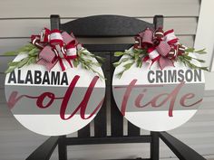 two christmas wreaths sitting on top of a chair with the words, alabama and crimson ridge painted on them