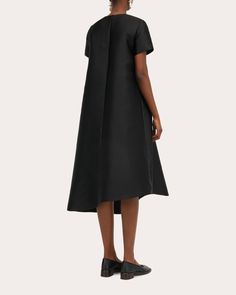 Made for the minimalist, the Doma dress is crafted from a technical silk blend for lustrous appeal. The dramatic A-line silhouette is finished with a slanted hem to create an asymmetric draped effect. Back keyhole clasp closure Asymmetric hem 86% polyester, 14% silk Dry clean Made in Romania Size & Fit Size EU 32 (US 0 / XXS): 31.5in bust, 24.02in waist, 34.25in hips, 14.33in shoulder width Size EU 34 (US 2 / XS): 33.07in bust, 25.59in waist, 35.83in hips, 14.72in shoulder width Size EU 36 (US 4 Made In Romania, Tan Woman, Black Midi Dress, Asymmetric Hem, A Line, Dry Clean, Midi Dress, Silk, Black