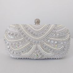 This sophisticated bridal clutch never fails to turn heads with its understated elegance and classic design. Adorned with creamy pearls and set with an array of sparkling sequins, this bridal clutch is the very picture of refinement. The crystal clasp and intricately encrusted front give this bridal clutch the look and feel of opulence and at the back of the clutch has the feel of smooth, soft satin. Available with a detachable long, metal shoulder chain, you can either drape your bridal clutch White Couture, Fancy Clutch, Bridal Clutch Bag, Beaded Clutch Purse, Pearl Clutch, Soul Contract, Wedding Bags, Crystal Bags, Crystal Clutch