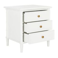 a white nightstand with three drawers and gold knobs on the bottom, against a white background