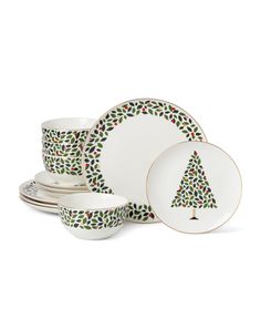 a christmas tree dinnerware set with matching plates and saucers in green, red and white