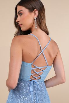 Your dazzling presence will be seen from any angle on the dance floor with a look like the Lulus Bold Aesthetic Blue Sequin Lace-Up Bodycon Mini Dress! Shimmering blue sequins decorate a mesh overlay (atop a matching knit liner) that shapes a sleeveless bodice with sheer mesh paneling at the back and supportive boning, a straight neckline, and slender straps that create a trendy lace-up design. The fitted waist tops a sexy bodycon skirt that ends at a flirty, notched mini hem. Hidden back zipper Blue Evening Dress With Corset Back For Gala, Glamorous Light Blue Fitted Evening Dress, Blue Evening Dress With Corset Back And Fitted Bodice, Glamorous Fitted Light Blue Evening Dress, Blue Dress With Boned Bodice And Spaghetti Straps, Fitted Light Blue Sequin Evening Dress, Blue Dress With Corset Back For Gala, Blue Prom Evening Dress With Corset Back, Blue Evening Dress With Corset Back