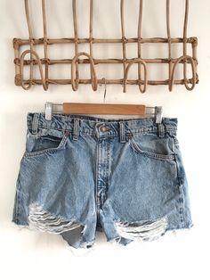 "Waist:32\" Rise:11.5\" Hips:39\" Inseam:2\" These are shown on a size 32\" model and are tagged a 34\" but are true vintage and run small. They're rad 90's 505 cutoffs with the rare orange Levis tab and tons of distress and rips by the raw hem. They're the perfect edgy summer shorts to pair with your Harley crops and band tees. 🍑(15)" Ripped High-rise Relaxed Fit Jean Shorts, Ripped High Rise Jean Shorts With Relaxed Fit, Ripped High Rise Relaxed Fit Jean Shorts, Distressed High Waist Relaxed Fit Jean Shorts, Distressed Relaxed Fit High-waisted Jean Shorts, Distressed High-waisted Jean Shorts In Relaxed Fit, Distressed High-waisted Jean Shorts Relaxed Fit, Vintage Distressed Cutoff Jean Shorts, Distressed Cutoff Jean Shorts With Relaxed Fit