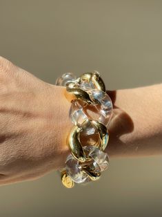 18k gold and crystal large link bracelet by Seaman Schepps. DESIGNER: Seaman Schepps MATERIAL: 18k Gold GEMSTONES: Crystal DIMENSIONS: Bracelet is 8 1/8" long end to end, approx. wearable length is 7-7.5", width 30mm. MARKED/TESTED: 1959, Seaman Schepps, Shell mark, 750. WEIGHT: 113.1 grams. CONDITION: Previously Owned, Excellent Condition. Clear Lucite Party Jewelry, Formal Clear Lucite Jewelry, Modern Lucite Bangle Jewelry, Round Lucite Jewelry For Parties, Clear Bracelet Jewelry For Party, Luxury Chain Link Party Bracelets, Luxury Chain Link Bracelets For Parties, Modern Clear Bracelet Jewelry, Formal Gold Lucite Jewelry