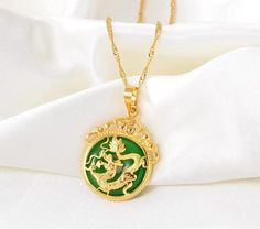 Unlock the power of positive energy with our Natural Jade Dragon Pendant Necklace, a stunning lucky charm crafted for protection and prosperity. This exquisite pendant offers: - Genuine jade for authentic beauty and rich symbolism - Luxurious gold-filled chain, perfect for everyday wear - Personalization options to layer and create a meaningful gift! At 18 inches, this necklace is designed to sit beautifully on any neckline. Our personalized name and birth flower necklace complements this necklace to make the perfect gift for the special women in your life. Layer the jade pendant with beautifully engraved necklace!  Specifications: - Necklace size: 56 cm  - Pendant size: 10x40mm Jade Dragon, Dragon Pendant, Natural Jade, Jade Pendant, Engraved Necklace, Lucky Charm, Gold Pendant Necklace, Necklace Sizes, Gold Filled Chain